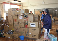 A classroom with many of boxes of relief aid in the evacuation center