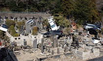 Cars and debris swept away by Tsunami into the cemetery nearby the evacuation center